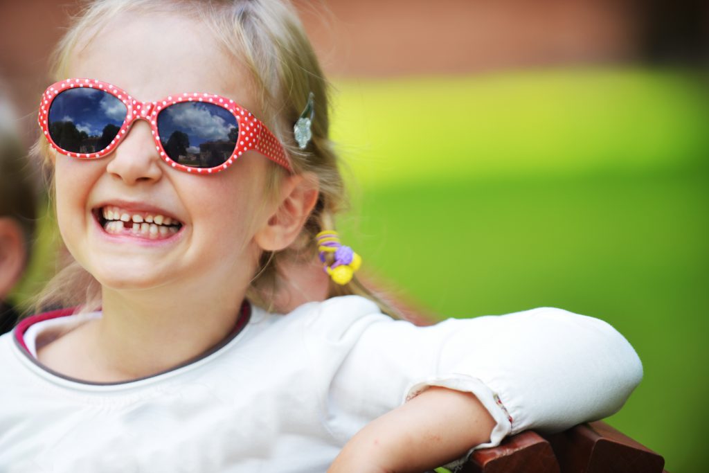 young girl smiling a tooth missing fixing baby teeth is important